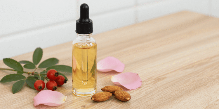 Oleo corporal caseiro de rosa mosqueta em frasco conta-gotas com frutos e petalas de rosa